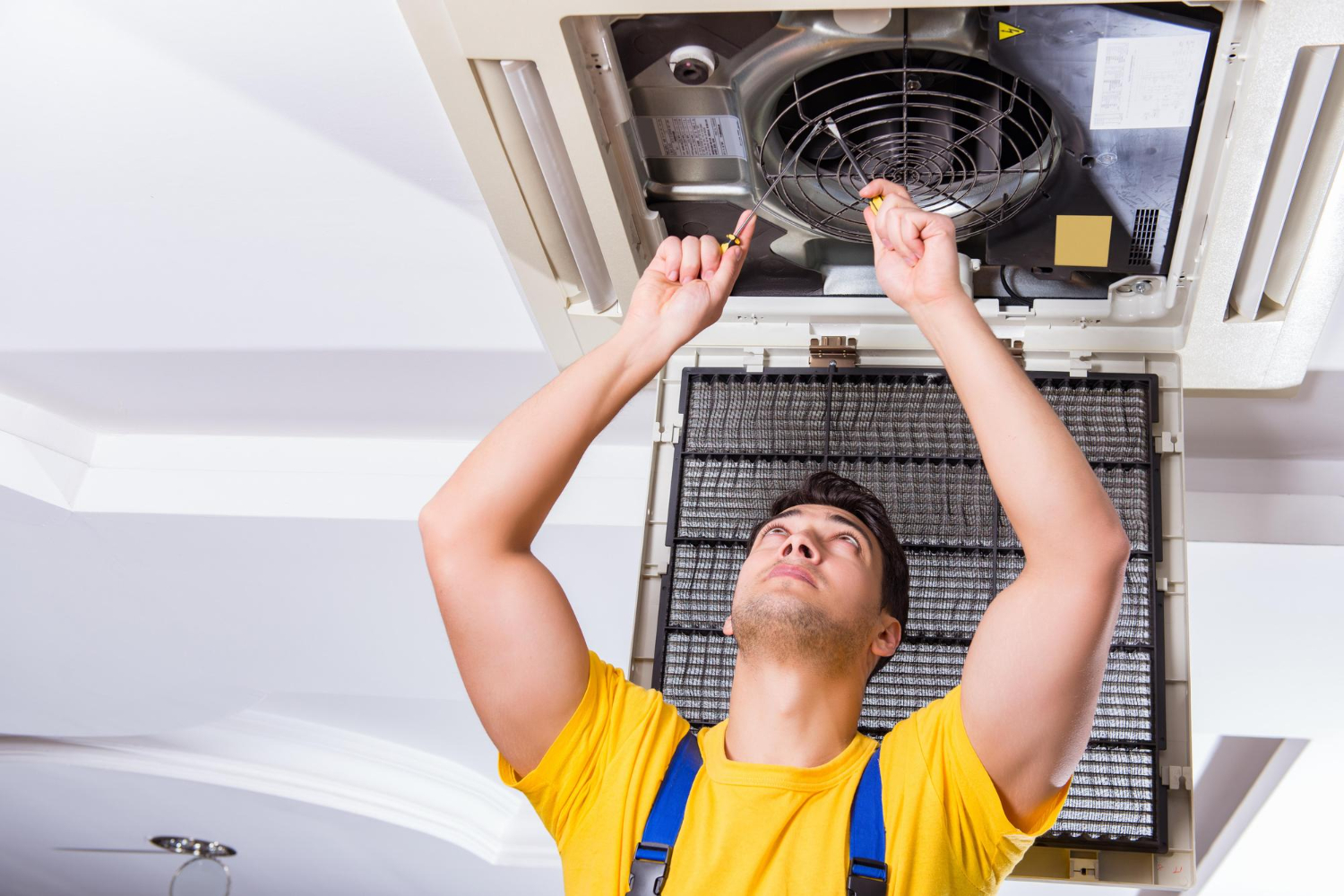 Technician repairing split AC unit
